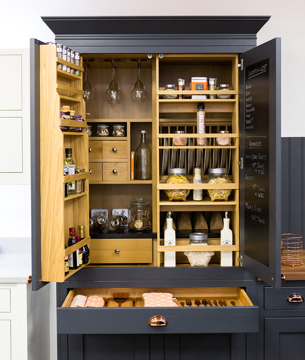 A SHAKER PANTRY INCORPORATING A TRADITIONAL BLACKBOARD AND POCKET SHELVES FOR SPICES